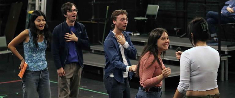 group of actors rehearsing backstage